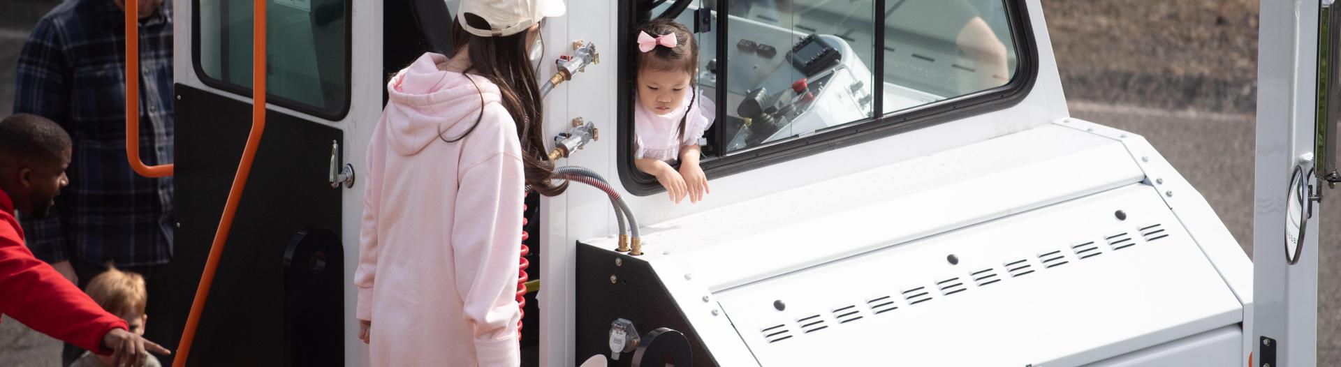A child in a yard truck. 