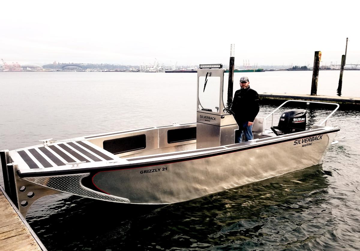 photo of a man in aluminum boat